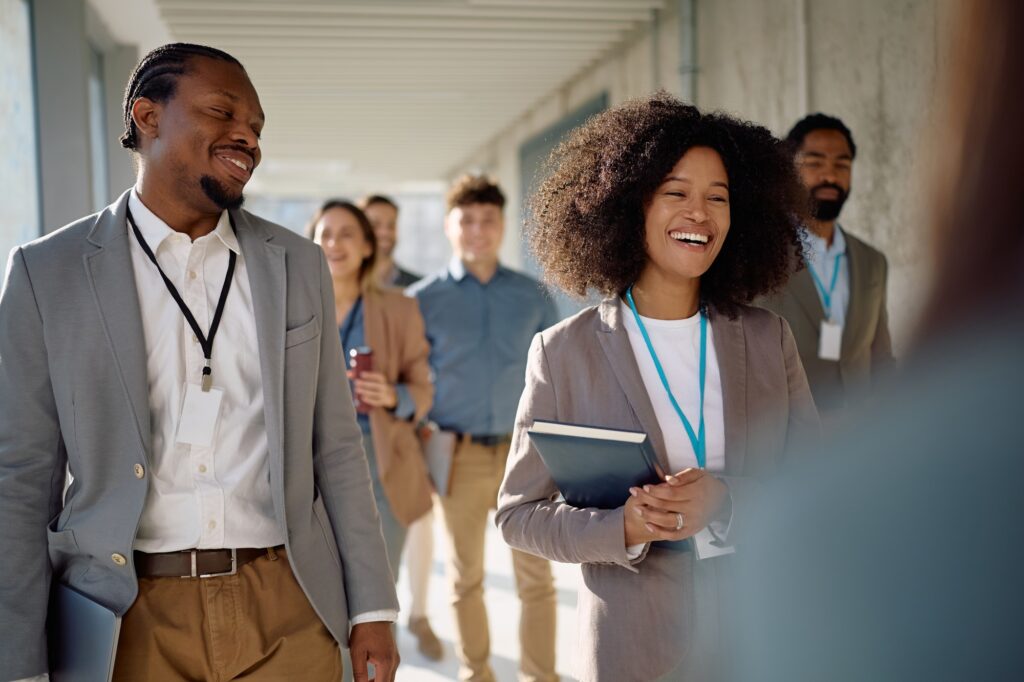 Happy entrepreneurs going on a business seminar at convention center.
